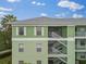 Light green building exterior with white accents and stairs at 2121 Heron Lake Dr # 301, Punta Gorda, FL 33983