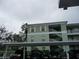 Partial view of building, parking area, and landscaping at 2121 Heron Lake Dr # 301, Punta Gorda, FL 33983