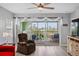 Living room with red couch and access to balcony at 2121 Heron Lake Dr # 301, Punta Gorda, FL 33983