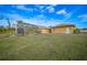 Backyard view of home with pool and screened enclosure at 215 Australian Dr, Rotonda West, FL 33947