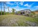 Large backyard with screened pool area and landscaping at 215 Australian Dr, Rotonda West, FL 33947