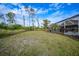 Spacious backyard with screened enclosure and lush landscaping at 215 Australian Dr, Rotonda West, FL 33947