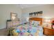 Bedroom with queen-size bed, dresser, and artwork at 215 Australian Dr, Rotonda West, FL 33947