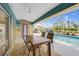 Covered patio with dining table and access to pool at 215 Australian Dr, Rotonda West, FL 33947
