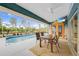 Relaxing patio area with a table, chairs, and pool view at 215 Australian Dr, Rotonda West, FL 33947