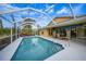 Screened pool area with patio furniture and a spacious deck at 215 Australian Dr, Rotonda West, FL 33947