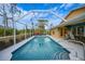 Inviting screened pool area with patio furniture and tranquil backyard views at 215 Australian Dr, Rotonda West, FL 33947