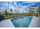 Relaxing screened pool and patio with surrounding lush landscape at 215 Australian Dr, Rotonda West, FL 33947