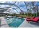 Inviting screened pool area with lounge chairs at 215 Australian Dr, Rotonda West, FL 33947