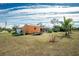 Large backyard with shed, screened enclosure, and tropical landscaping at 2194 Wenona Dr, North Port, FL 34288