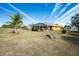 Spacious backyard with screened lanai and fire pit at 2194 Wenona Dr, North Port, FL 34288