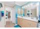 Double vanity bathroom with access to bedroom and another bathroom at 2194 Wenona Dr, North Port, FL 34288