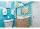 Light beige vanity in a teal-walled bathroom at 2194 Wenona Dr, North Port, FL 34288