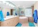Bathroom with a large soaking tub and double vanity at 2194 Wenona Dr, North Port, FL 34288