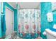 Bathroom with teal walls and seashell-themed shower curtain at 2194 Wenona Dr, North Port, FL 34288