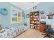 Cozy bedroom with a twin-size bed, built-in shelving, and window with shutters at 2194 Wenona Dr, North Port, FL 34288