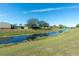 Peaceful canal view with lush green landscape at 2194 Wenona Dr, North Port, FL 34288