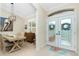 Dining room with a rustic table, chandelier, and access to the entryway at 2194 Wenona Dr, North Port, FL 34288