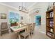 Bright dining area with a rustic table and bookcase at 2194 Wenona Dr, North Port, FL 34288