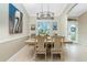 Elegant dining room with a rustic table and chandelier at 2194 Wenona Dr, North Port, FL 34288