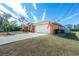 Orange house with a two-car garage and American flag at 2194 Wenona Dr, North Port, FL 34288