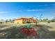 Orange single story house with landscaping and a blue sky at 2194 Wenona Dr, North Port, FL 34288