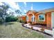 Orange house with a landscaped yard and walkway at 2194 Wenona Dr, North Port, FL 34288