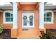 Double front doors with wreaths, a doormat, and columns at 2194 Wenona Dr, North Port, FL 34288