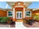 Front entrance with double doors, columns, and landscaping at 2194 Wenona Dr, North Port, FL 34288
