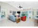 Relaxing living room with light blue couch, orange chairs, and view of pool at 2194 Wenona Dr, North Port, FL 34288