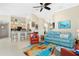 Open living space with a blue couch and a view of the kitchen at 2194 Wenona Dr, North Port, FL 34288