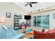 Living area with blue couch, orange chairs, and access to backyard pool at 2194 Wenona Dr, North Port, FL 34288