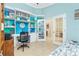 Home office with built-in shelves, desk, and view into adjacent room at 2194 Wenona Dr, North Port, FL 34288