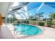 Screened, kidney-shaped pool with a spacious deck at 2194 Wenona Dr, North Port, FL 34288