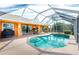 Relaxing kidney-shaped pool with a screened enclosure at 2194 Wenona Dr, North Port, FL 34288