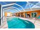 Enclosed kidney shaped pool and patio area at 2194 Wenona Dr, North Port, FL 34288