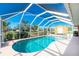Enclosed kidney-shaped swimming pool in backyard at 2194 Wenona Dr, North Port, FL 34288