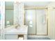 Bright bathroom with shower stall, white vanity, and colorful wallpaper at 2424 Placida Rd # C101, Englewood, FL 34224