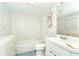 Clean bathroom with white vanity and tiled walls at 2424 Placida Rd # C101, Englewood, FL 34224