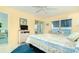 Main bedroom with water views and wicker furniture at 2424 Placida Rd # C101, Englewood, FL 34224