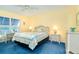 Bedroom with wicker furniture and blue carpet at 2424 Placida Rd # C101, Englewood, FL 34224