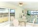 Dining area with glass table and wicker chairs near balcony with water view at 2424 Placida Rd # C101, Englewood, FL 34224