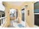 Front door and small seating area on condo balcony at 2424 Placida Rd # C101, Englewood, FL 34224