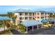Attractive waterfront condo building with parking and tropical landscaping at 2424 Placida Rd # C101, Englewood, FL 34224