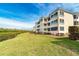 Condo building showcasing manicured lawn and water views at 2424 Placida Rd # C101, Englewood, FL 34224