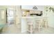 Bright kitchen with white cabinets, modern appliances, and a breakfast bar at 2424 Placida Rd # C101, Englewood, FL 34224