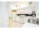 White kitchen features an electric range, microwave, and refrigerator at 2424 Placida Rd # C101, Englewood, FL 34224