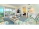 Living room with water view, couches, and patio access at 2424 Placida Rd # C101, Englewood, FL 34224