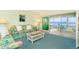 Living room with water view and access to a balcony at 2424 Placida Rd # C101, Englewood, FL 34224