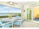 Sunroom with water views and casual dining area at 2424 Placida Rd # C101, Englewood, FL 34224